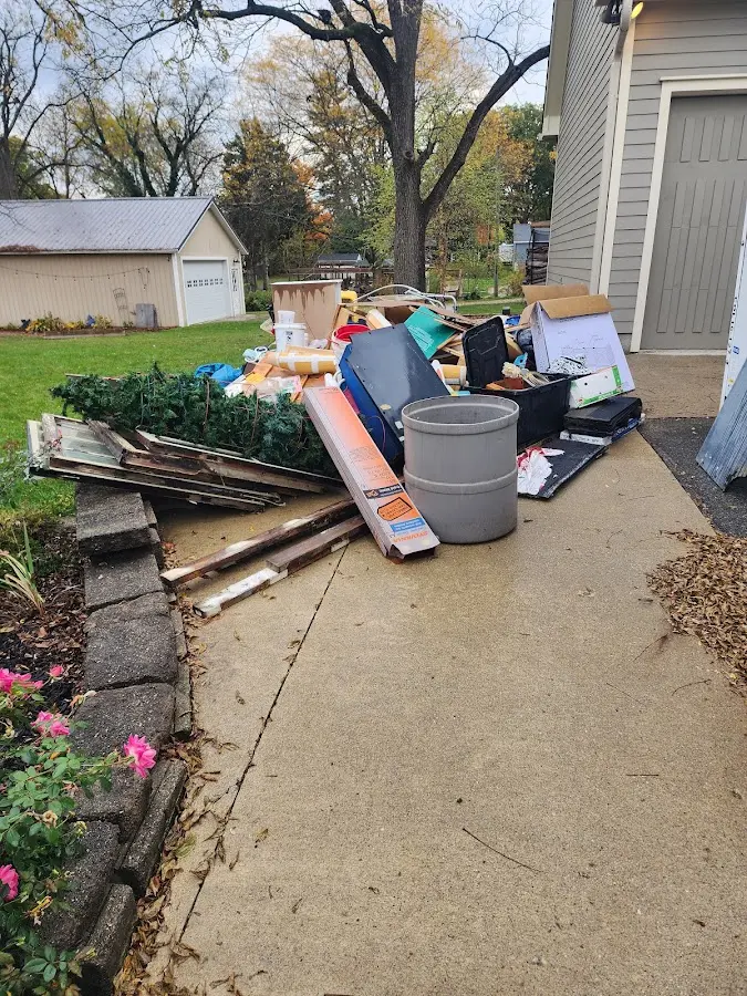 Dumpster being loaded with debris for 12 Yard Dumpster Rental in Bucksport